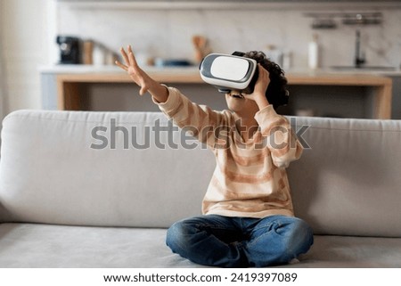 Similar – Image, Stock Photo Boy with virtual reality glasses on colorful background. Future technology, VR concept