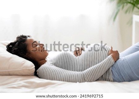 Similar – Image, Stock Photo pregnant black woman relaxing on bed with a laptop at home