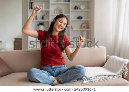 Similar – Image, Stock Photo Joyful Asian resting female in casual clothing looking out modern wall of building at city street