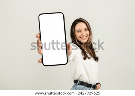 Image, Stock Photo Millennial young brunette woman looking at camera and standing in creative office with grange blue green wall, soft chair and rattan lamps . Successful self-confident female designer. copy space