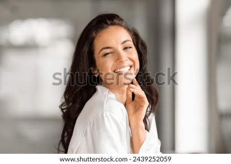 Similar – Image, Stock Photo Pretty brunette, long-haired young woman, teenager, teenager smiles naturally into the camera, in front of a grey wall on vacation. Happy girl with blue eyes, in front of a rock by the sea, on the beach during the summer holidays, looking forward to holidays and summer fun.