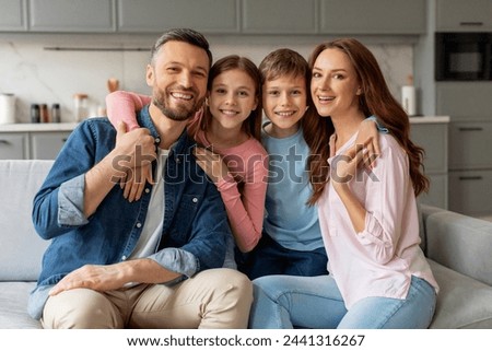 Similar – Foto Bild Junge Eltern und ihr kleiner Sohn sitzen auf dem Holzsteg in der Nähe des Sees, bei Sonnenuntergang am Sommertag.