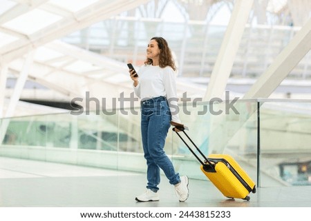 Similar – Image, Stock Photo Casual woman on airport terminal talking on the cell phone, waiting for flight departure with luggage on trolley cart.