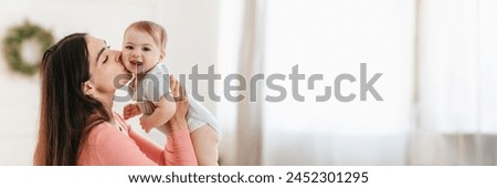 Similar – Image, Stock Photo Adorable mother and child on hand enjoying and laughing in field