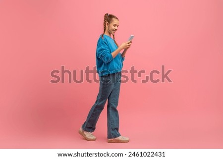 Similar – Image, Stock Photo teenager looks at her mobile phone