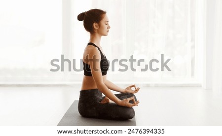 Similar – Image, Stock Photo Focused athletes practicing yoga together performing supported shoulderstand balance position in contemporary gym