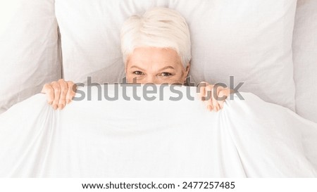 Similar – Image, Stock Photo Positive lady hiding under blanket at home