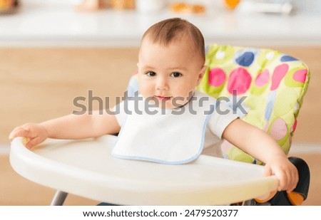 Similar – Image, Stock Photo Young baby sitting in high chair looking towards window; interior of home with vintage furniture