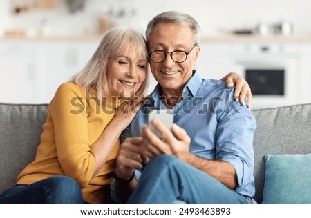 Image, Stock Photo Couple using smartphone together on bench