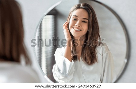 Similar – Image, Stock Photo young pretty woman looking camera in shorts while standing on the street holding a skateboard at night in the city