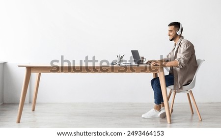 Image, Stock Photo A man with headphones pulls on his tongue with pliers