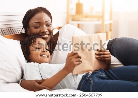 Image, Stock Photo Mother reading book her daughter in bed before going to sleep. Bedtime stories for child