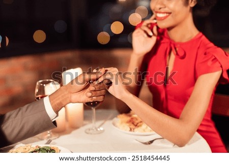 Similar – Image, Stock Photo Black girlfriends holding hands together on seashore