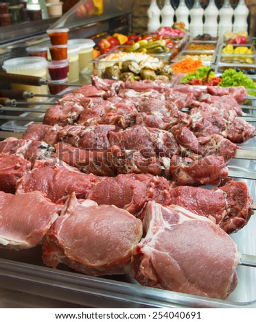 Various fresh raw meat prepared for barbecue in a store