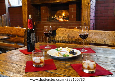 Romantic dinner for two near fireplace - wine and cheese plate