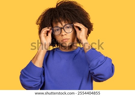 Similar – Image, Stock Photo Trendy young guy adjusting futuristic sunglasses in neon studio