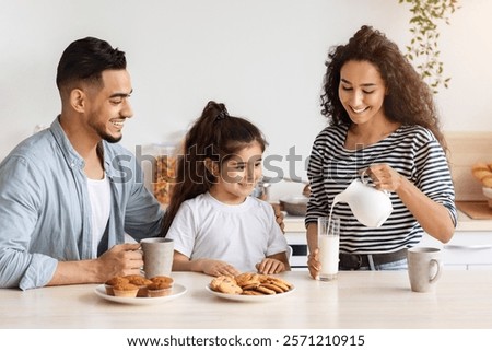 Similar – Image, Stock Photo Woman pouring fresh milk from bottle to enamel mug while having refreshment in garden