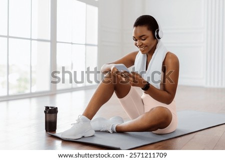 Similar – Image, Stock Photo Sportswoman in headset using social media on smartphone after workout