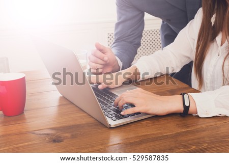 stock-photo-closeup-of-businessman-s-hand-supervising-his-assistant-s-work-on-the-laptop-computer-man-helps-529587835.jpg
