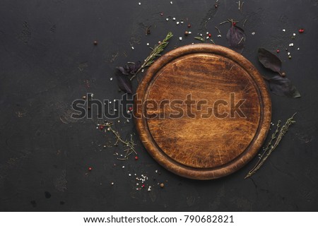 Similar – Image, Stock Photo Food background with empty wooden cutting board, herbs, garlic, olive oil, spices on grey concrete kitchen table. Cooking with fresh, flavorful ingredients. Top view with copy space.