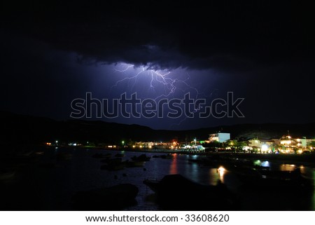A lightning strike from a late night storm at the sea