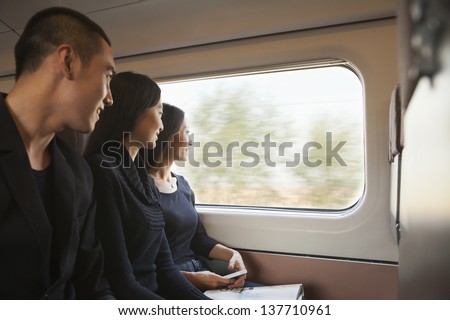 Three Friends Looking Out Train Window
