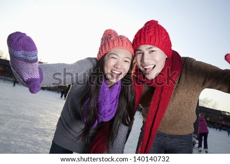 Young couple at ice rink