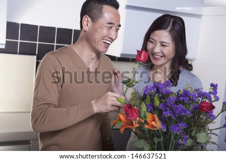 Mature Couple with Bouquet of Flowers, Man Holding a Rose
