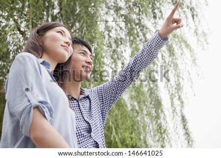 Young Man Pointing Something Out to His Girlfriend