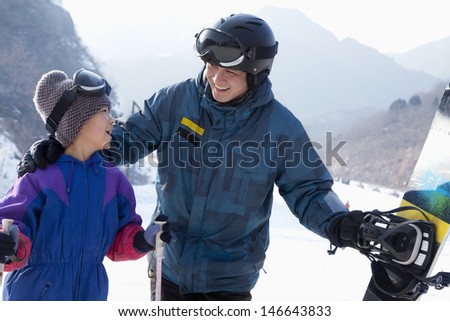 Father and Son with Ski Gear in Ski Resort