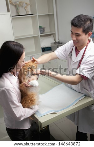 Woman with pet dog in veterinarian\'s office
