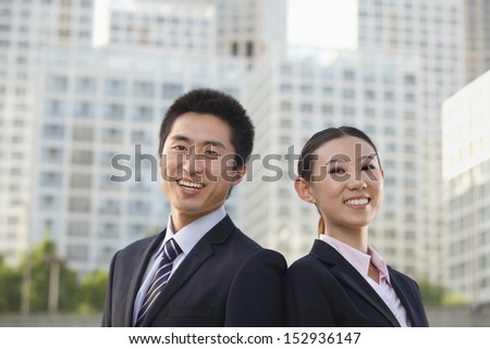 Portrait of two young business people outside in the business district, Beijing