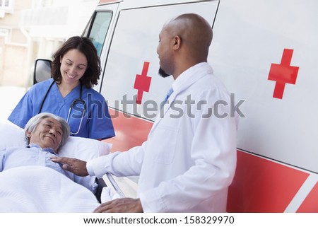 Similar – Image, Stock Photo Group of doctors transporting patient to operating room