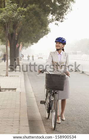 Young Business Woman commuting with bicycle in Beijing