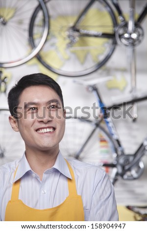 Portrait of young male mechanic in bicycle store