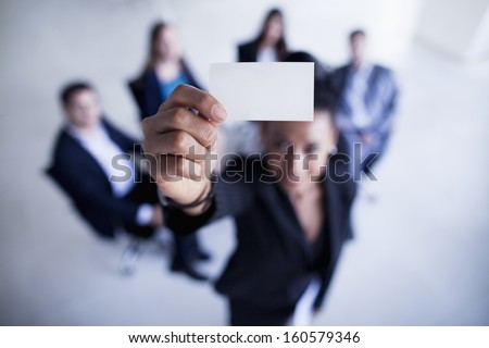 Businesswoman holding business card up to camera
