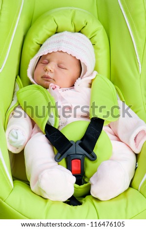 Newborn baby in a Car Seat on a white background