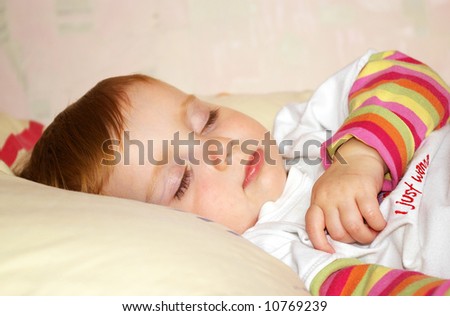 Beautiful little girl in a bright jacket sleeps
