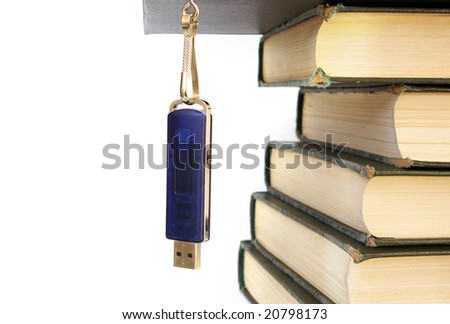 Books stack and flash memory isolated on white