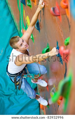 men climbing on a wall in an outdoor climbing center