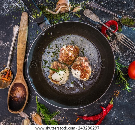 meatballs cooked at home in the old frying pan on a dark background