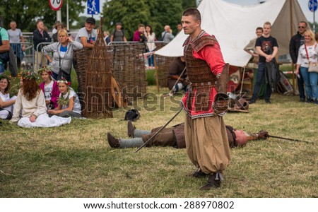 Warsaw, Poland -JUNE 20: Polish man show mastery of the sword on a festival of midsommar near the old town in Warsaw, Poland June 20, 2015