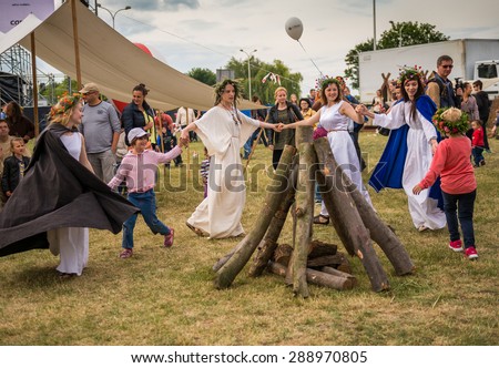 Warsaw, Poland -JUNE 20: People dance around a bonfire logs on a festival of midsommar near the old town in Warsaw, Poland June 20, 2015