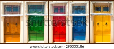 photo collage of five colourful front doors to houses