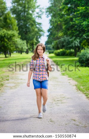 Beautiful teenager girl in casual clothes going to school on sunny september day, outdoor portrait