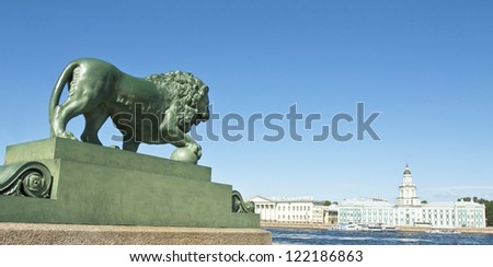 St. Petersburg, Russia, sculpture of lion and Museum of anthropology and ethnography (Cabinet of curiosities) on quay of river Neva.