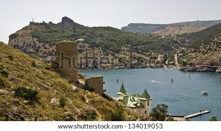 Sea lanscape with ruins of old castle and rocks near sea bay, recorded in place Balaclava in region Crimea on Black sea.