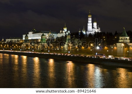 Moscow, Kremlin fortress with palace and cathedrals inside on bank of Moscow-river at night.