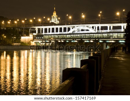 Moscow, Andreevskiy birdge on Moscow-river at night and building of Moscow State University.