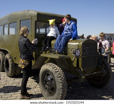 MOSCOW - MAY 9, 2014: Holiday Victory Day devoted to victory in Second World War, children play on exhibition of military technique in memorial Poklonnaya hill.